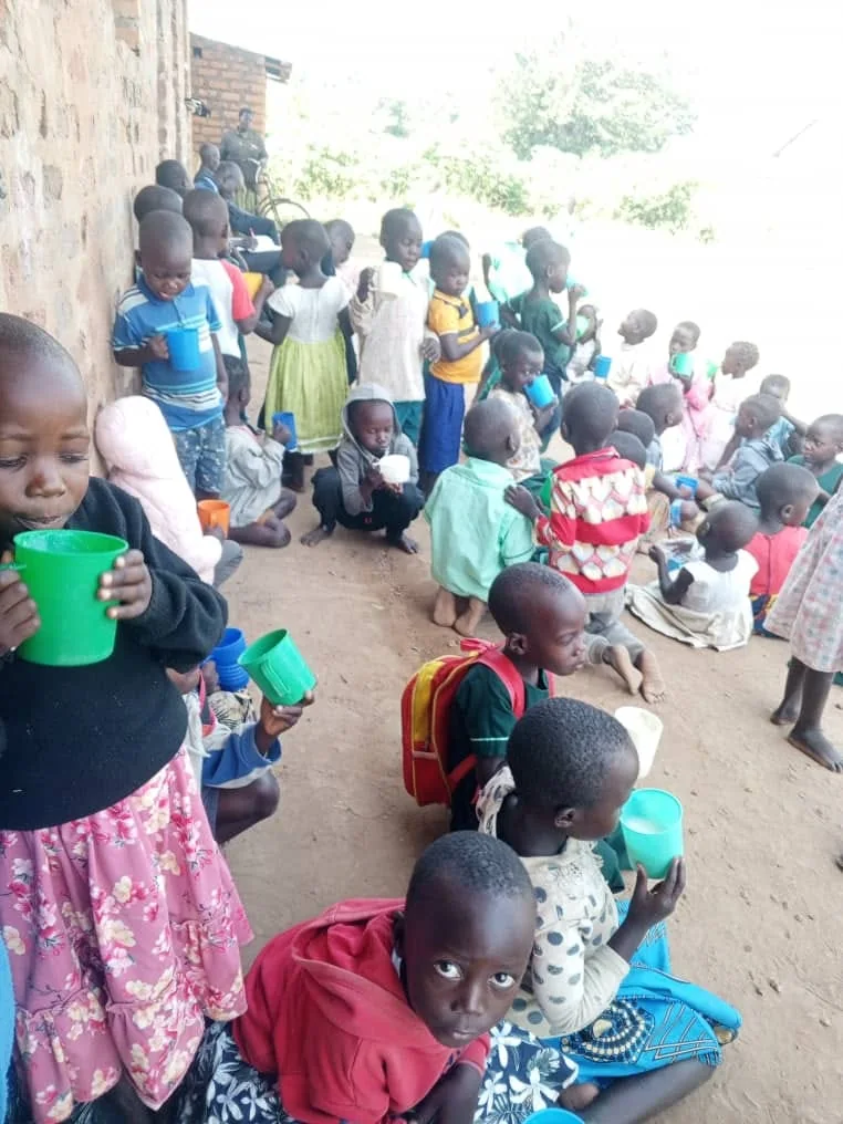 Children sharing drinks together during a community activity.