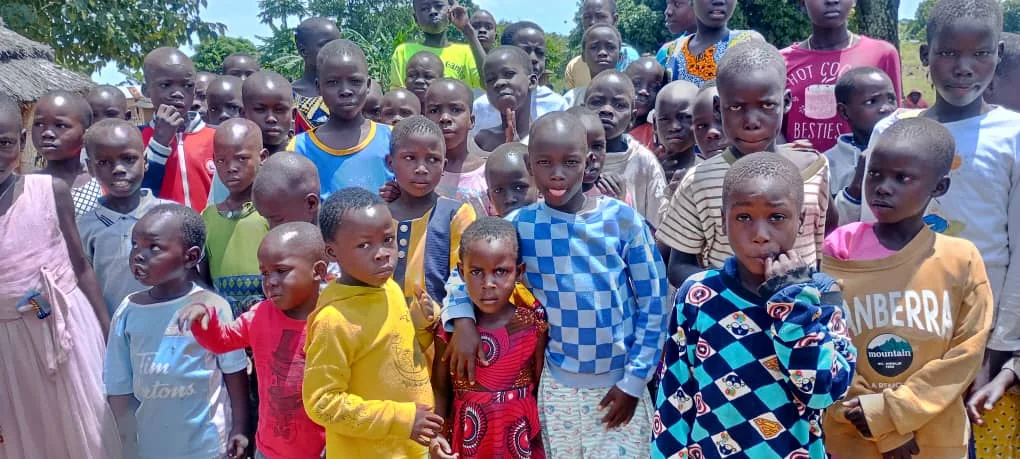 Children standing together during a community gathering in Uganda