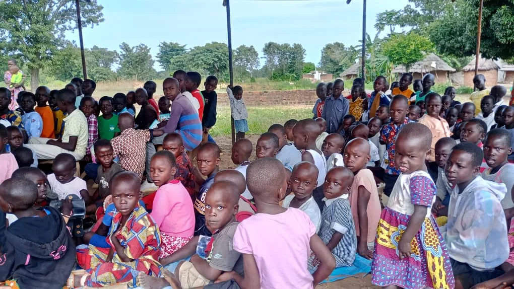 Children and caregivers gathered during a community support day